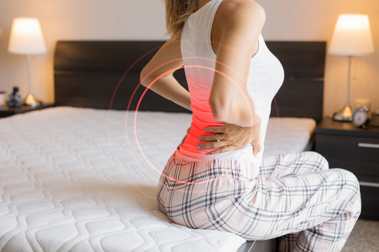 Woman suffering from back pain due to old mattress